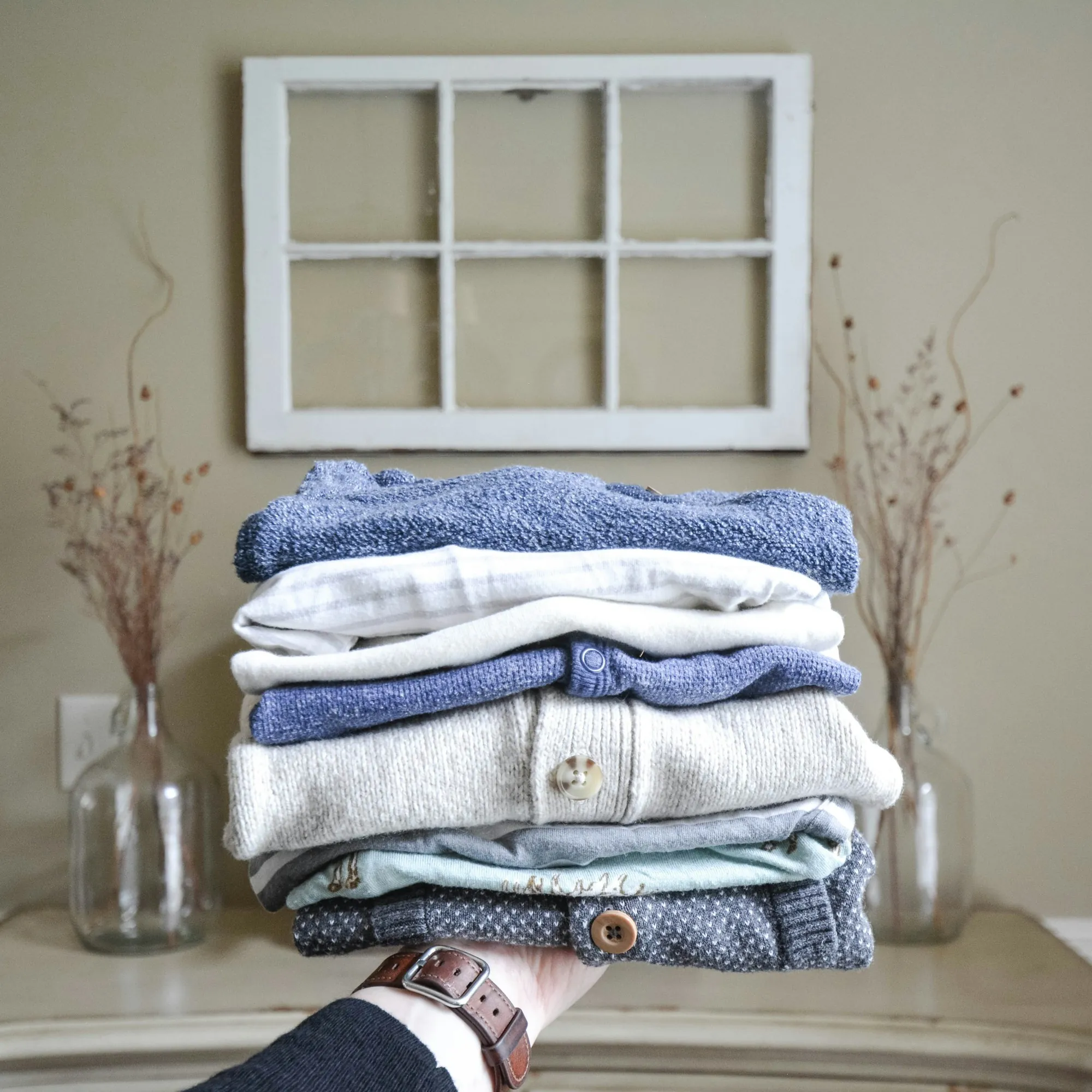 A stack of folded laundry being carried